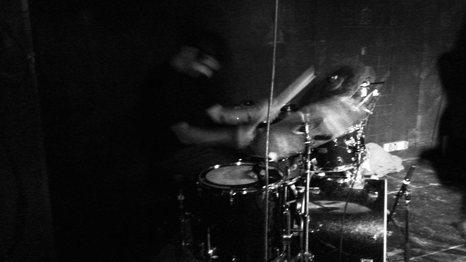 Drummer performing in black and white